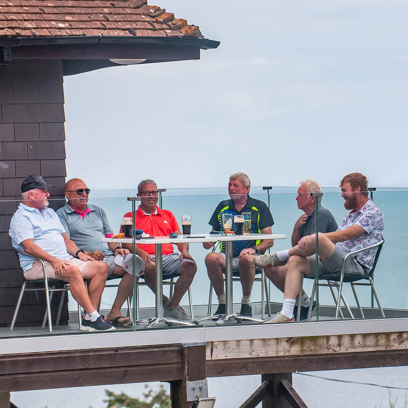 Members enjoying drinks on the clubhouse terrace overlooking Sidmouth seafront